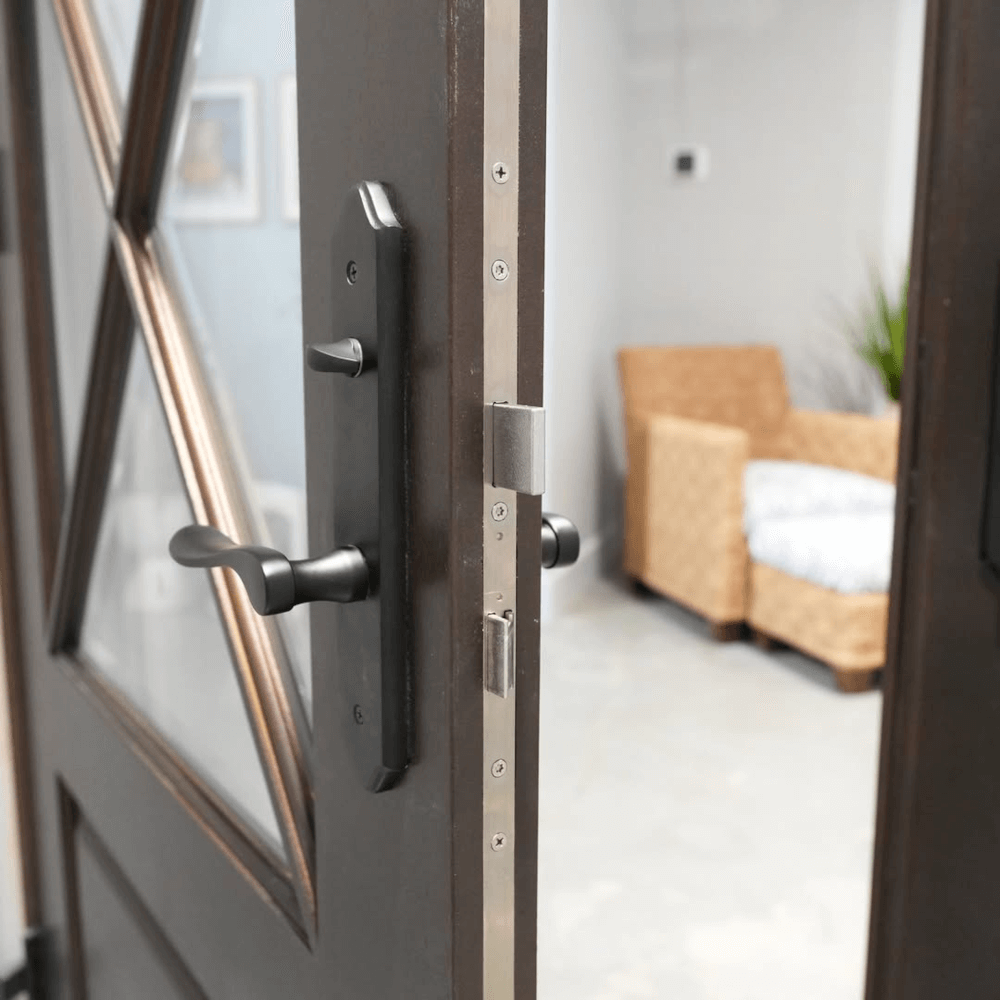 Automatic multipoint locking system shown on an exterior door edge, featuring top, center, and bottom locking points with a lever handleset.